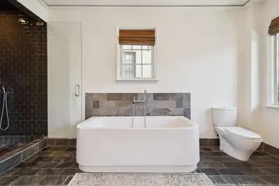 a white bath tub in a bathroom with a toilet at Ocean`s Six by 30A Escapes in Rosemary Beach