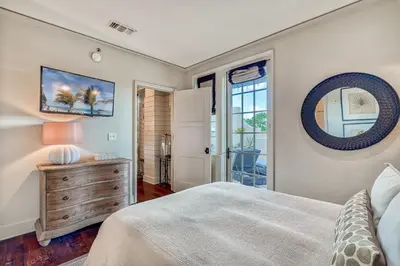 a bedroom with a bed and a dresser and a mirror at 6 Barrett Place by 30A Escapes in Rosemary Beach