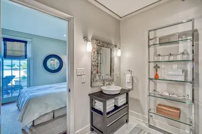 a bathroom with a bed and a sink and a mirror at 6 Barrett Place by 30A Escapes in Rosemary Beach