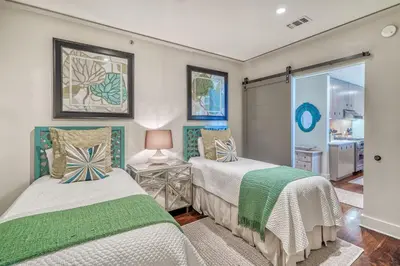 a bedroom with two beds and a window at 6 Barrett Place by 30A Escapes in Rosemary Beach