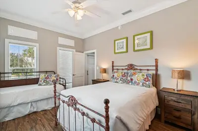 a bedroom with a bed and a ceiling fan at All In - Seacrest by 30A Escapes in Seacrest