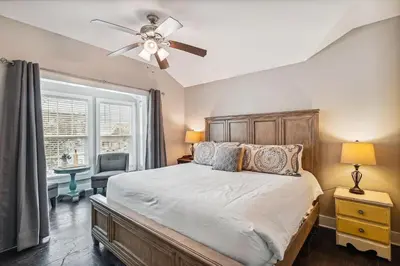 a bedroom with a bed and a ceiling fan at All In - Seacrest by 30A Escapes in Seacrest
