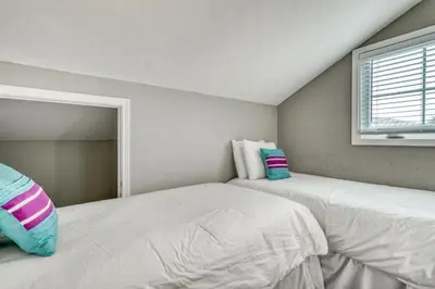 two white beds in a room with a window at All In - Seacrest by 30A Escapes in Seacrest