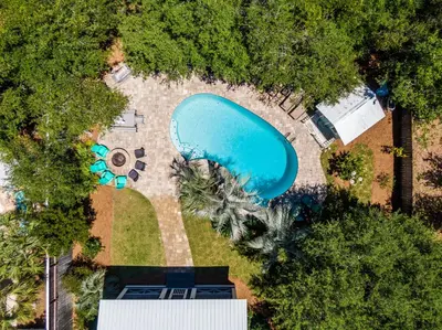 an overhead view of a swimming pool with trees at All In - Seacrest by 30A Escapes in Seacrest