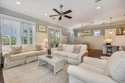 a living room with white furniture and a ceiling fan at Moon Landing by 30A Escapes in Watersound Beach