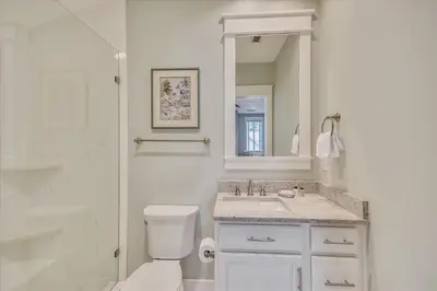 a bathroom with a toilet and a sink and a shower at Moon Landing by 30A Escapes in Watersound Beach