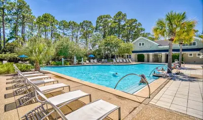 a swimming pool with lounge chairs and a resort at Moon Landing by 30A Escapes in Watersound Beach