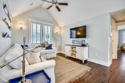 a living room with white furniture and a ceiling fan at Moon Landing by 30A Escapes in Watersound Beach