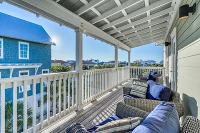 a patio with couches and chairs on a deck at As Good as it Gets by 30A Escapes in Rosemary Beach