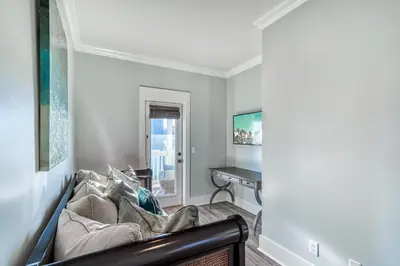 a living room with a couch and a piano at As Good as it Gets by 30A Escapes in Rosemary Beach
