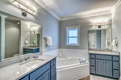 a bathroom with two sinks and a tub and a large mirror at As Good as it Gets by 30A Escapes in Rosemary Beach