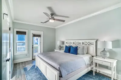 a bedroom with a bed and a ceiling fan at As Good as it Gets by 30A Escapes in Rosemary Beach