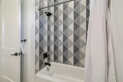 a bathroom with a shower curtain and a sink at Sea Star by 30A Escapes in Seacrest