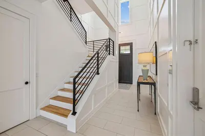 a staircase in a home with a table and a lamp at Sea Star by 30A Escapes in Seacrest