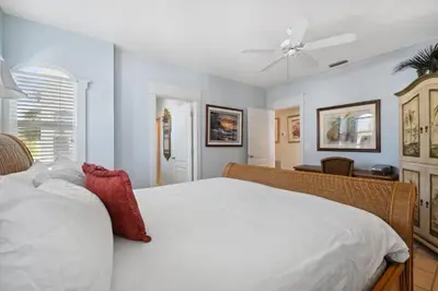 a bedroom with a white bed and a ceiling fan at Sunset Beach 202B by 30A Escapes in Rosemary Beach