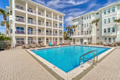 a swimming pool in front of a building at Sunset Beach 202B by 30A Escapes in Rosemary Beach
