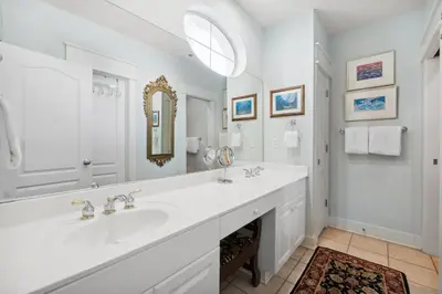 a white bathroom with two sinks and a mirror at Sunset Beach 202B by 30A Escapes in Rosemary Beach