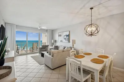 a dining room and living room with a table and chairs at HP 34E On the Gulf by 30A Escapes in Rosemary Beach