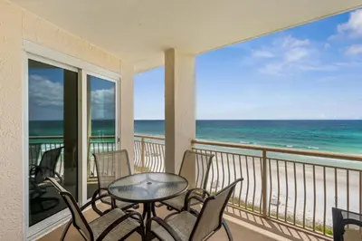 a balcony with a table and chairs and the ocean at HP 34E On the Gulf by 30A Escapes in Rosemary Beach