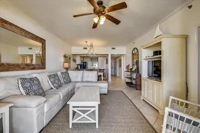 a living room with a couch and a ceiling fan at HP 12W Gulf Front Condo by 30A Escapes in Rosemary Beach