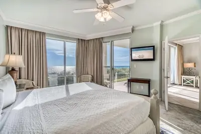 a bedroom with a white bed and a large window at HP 12W Gulf Front Condo by 30A Escapes in Rosemary Beach