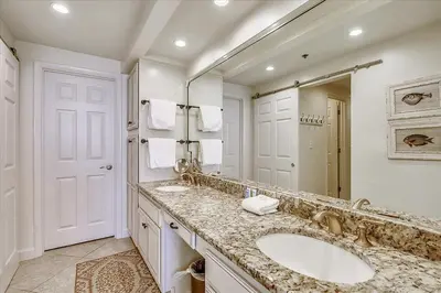 a bathroom with two sinks and a large mirror at HP 12W Gulf Front Condo by 30A Escapes in Rosemary Beach