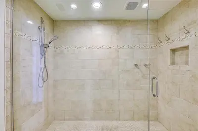 a bathroom with a shower with a glass door at HP 12W Gulf Front Condo by 30A Escapes in Rosemary Beach