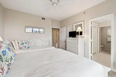 a bedroom with a white bed and a television at HP 16E Beach Treat by 30A Escapes in Rosemary Beach