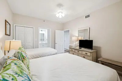 a bedroom with two beds and a flat screen tv at HP 16E Beach Treat by 30A Escapes in Rosemary Beach