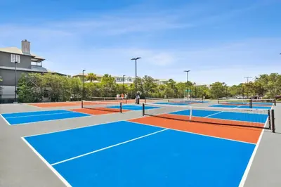 a group of tennis courts with blue at HP 16E Beach Treat by 30A Escapes in Rosemary Beach