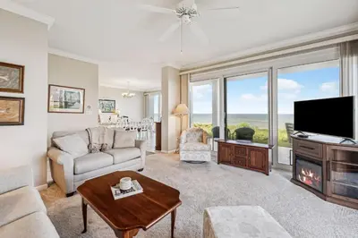 a living room with a couch and a tv at HP 16E Beach Treat by 30A Escapes in Rosemary Beach
