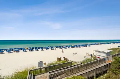 a view of a beach with chairs and umbrellas at HP 15W Salt and Light by 30A Escapes in Rosemary Beach