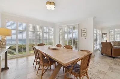 a dining room with a wooden table and chairs at HP 16W Seadawg by 30A Escapes in Rosemary Beach