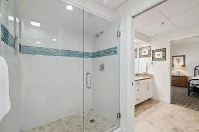 a bathroom with a shower with a glass door at HP 16W Seadawg by 30A Escapes in Rosemary Beach