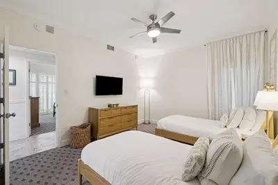 a bedroom with two beds and a flat screen tv at HP 16W Seadawg by 30A Escapes in Rosemary Beach