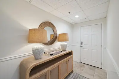 a room with a table with two lamps and a mirror at HP 16W Seadawg by 30A Escapes in Rosemary Beach