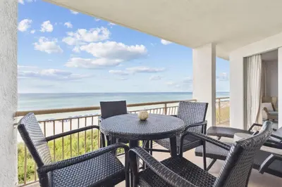 a balcony with a table and chairs and the ocean at HP 23W Calypso Crossing by 30A Escapes in Rosemary Beach