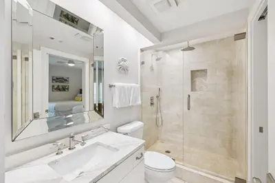 a white bathroom with a sink and a shower at HP 23W Calypso Crossing by 30A Escapes in Rosemary Beach