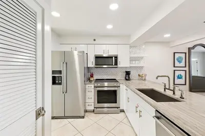 a kitchen with a stainless steel refrigerator and a sink at HP 23W Calypso Crossing by 30A Escapes in Rosemary Beach