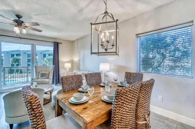 a dining room with a table and chairs at HP 315 Condo by 30A Escapes in Rosemary Beach