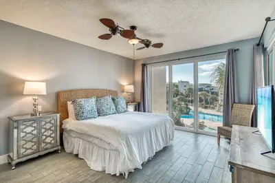 a bedroom with a bed and a view of a pool at HP 315 Condo by 30A Escapes in Rosemary Beach