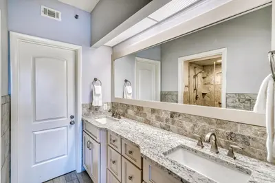 a bathroom with two sinks and a large mirror at HP 315 Condo by 30A Escapes in Rosemary Beach