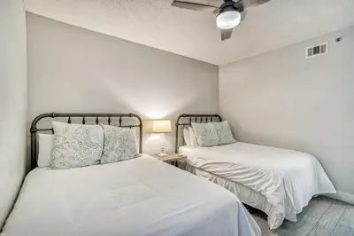 a bedroom with two beds and a ceiling fan at HP 315 Condo by 30A Escapes in Rosemary Beach