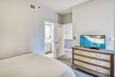 a bedroom with a bed and a tv on a dresser at HP 315 Condo by 30A Escapes in Rosemary Beach