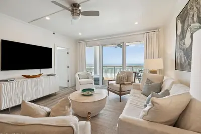 a living room with a tv and a couch and chairs at HP 24W Condo by 30A Escapes in Rosemary Beach