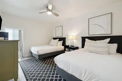 a bedroom with two beds and a ceiling fan at HP 24W Condo by 30A Escapes in Rosemary Beach