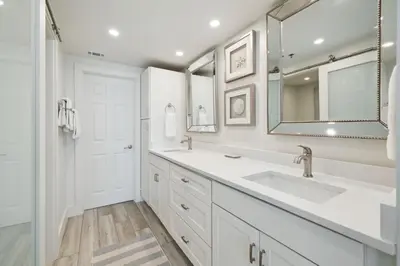 a white bathroom with two sinks and a mirror at HP 24W Condo by 30A Escapes in Rosemary Beach