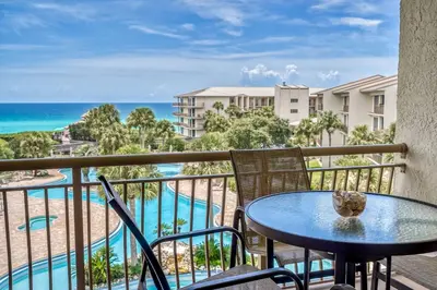 a balcony with a table and chairs and the ocean at HP 422 Blue Haven by 30A Escapes in Rosemary Beach