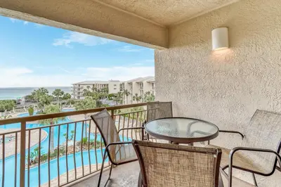 a balcony with a table and chairs and a view of the ocean at HP 422 Blue Haven by 30A Escapes in Rosemary Beach