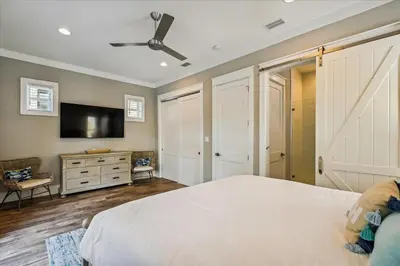 a bedroom with a bed and a flat screen tv at Makin Memories by 30A Escapes in Rosemary Beach